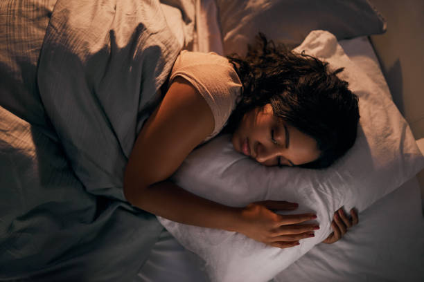 High angle shot of a beautiful young woman sleeping in her bed at home during the night