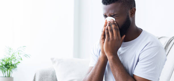 black man blowing his nose