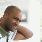 Man rubbing the back of his neck