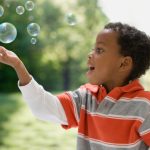 boy-child-blowing-bubbles-park-04202015-