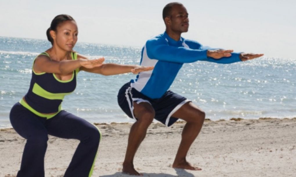 Man and woman doing squats 