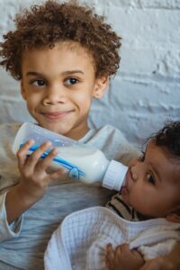 toddler feeding baby