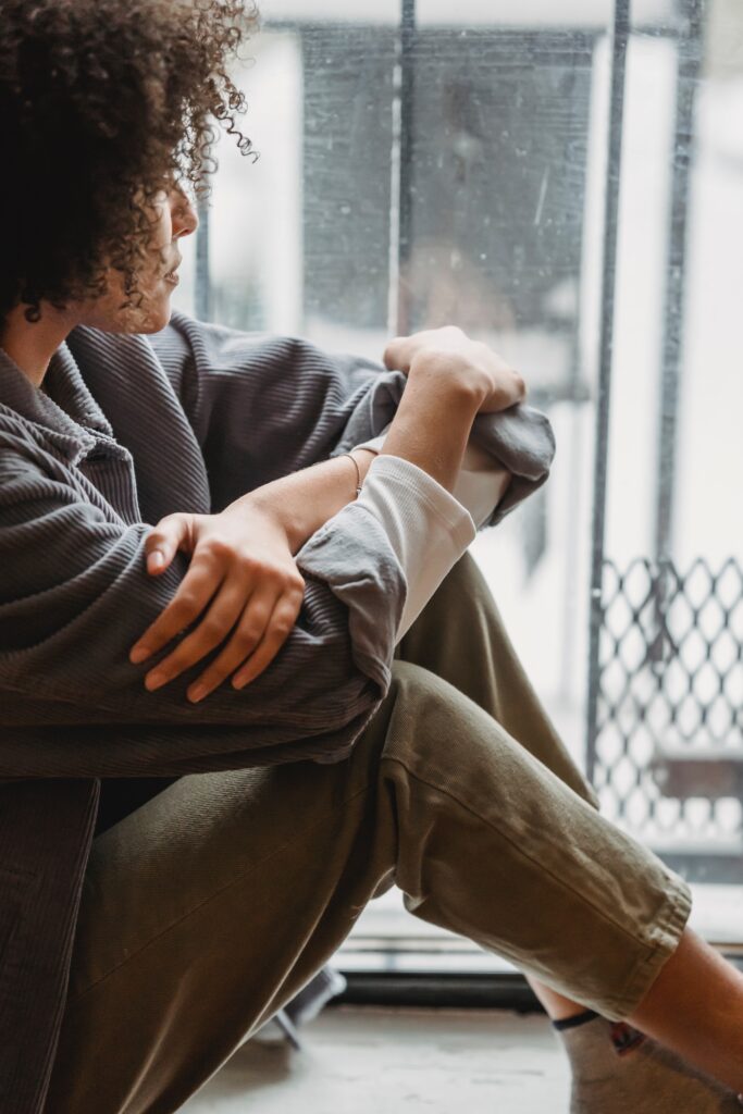 woman looking out a window due to poor mental health during holidays