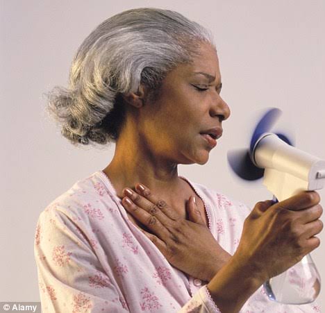 A  woman 
 with hot flash
es, depicting the first stage of menopause 