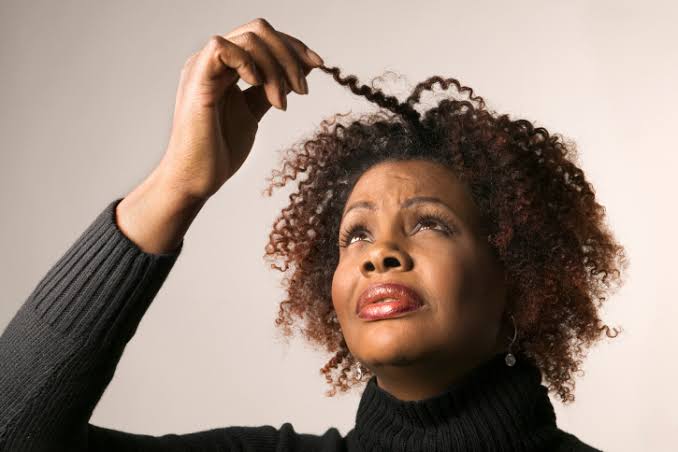 Thinning hair, a sign of menopause.
