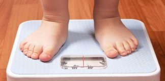 Shows an overweight child on a scale