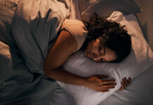 High angle shot of a beautiful young woman sleeping in her bed at home during the night