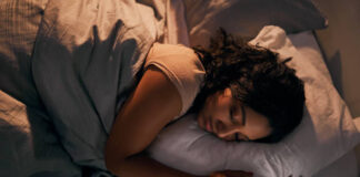 High angle shot of a beautiful young woman sleeping in her bed at home during the night