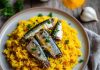 A plate of turmeric rice and sardines