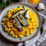 A plate of turmeric rice and sardines
