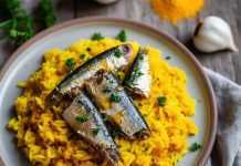 A plate of turmeric rice and sardines