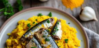 A plate of turmeric rice and sardines